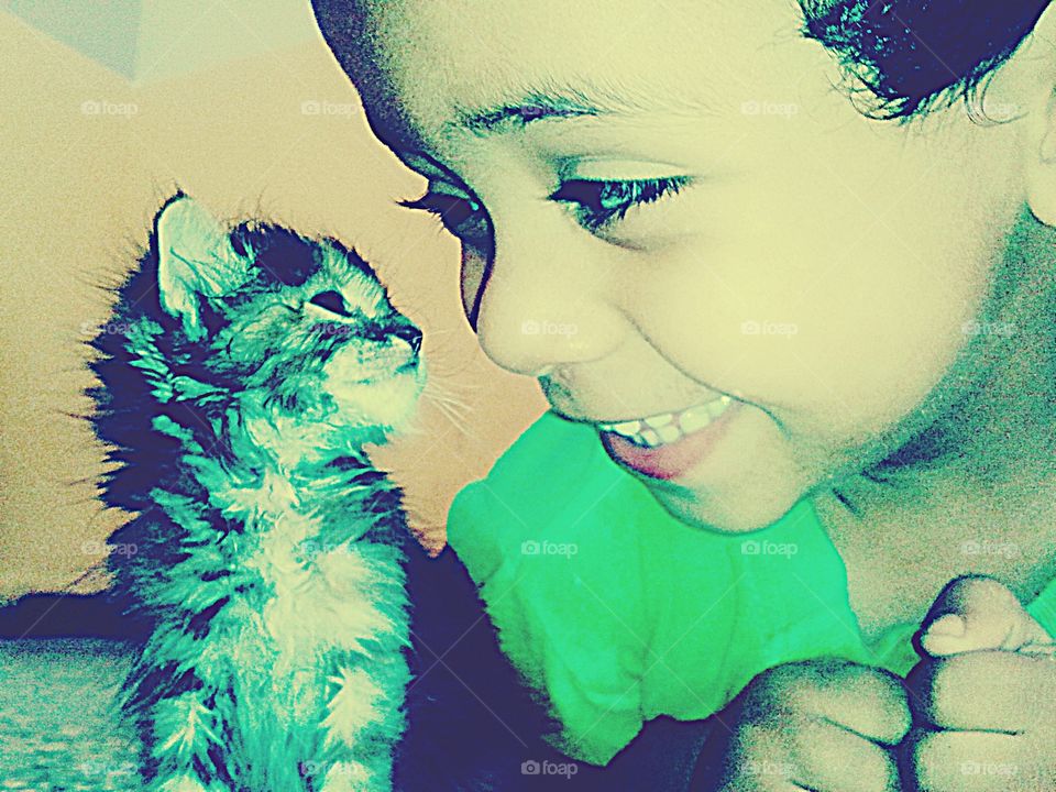 Smiling boy with little kitten