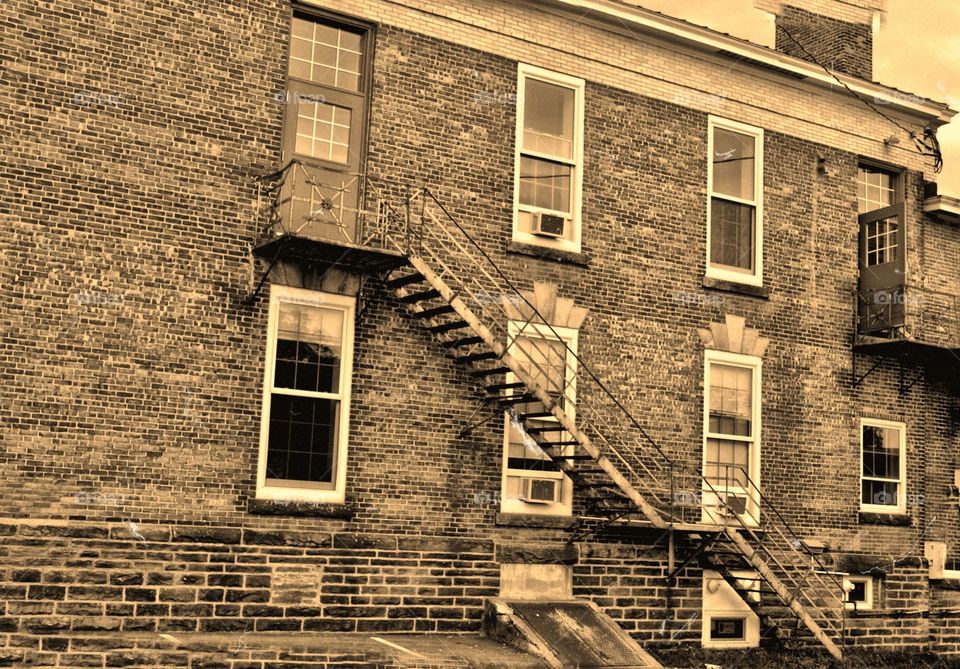 Fire escape, rear old building. Fire escape at rear of old brick building