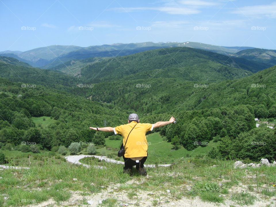 man jumping over hill