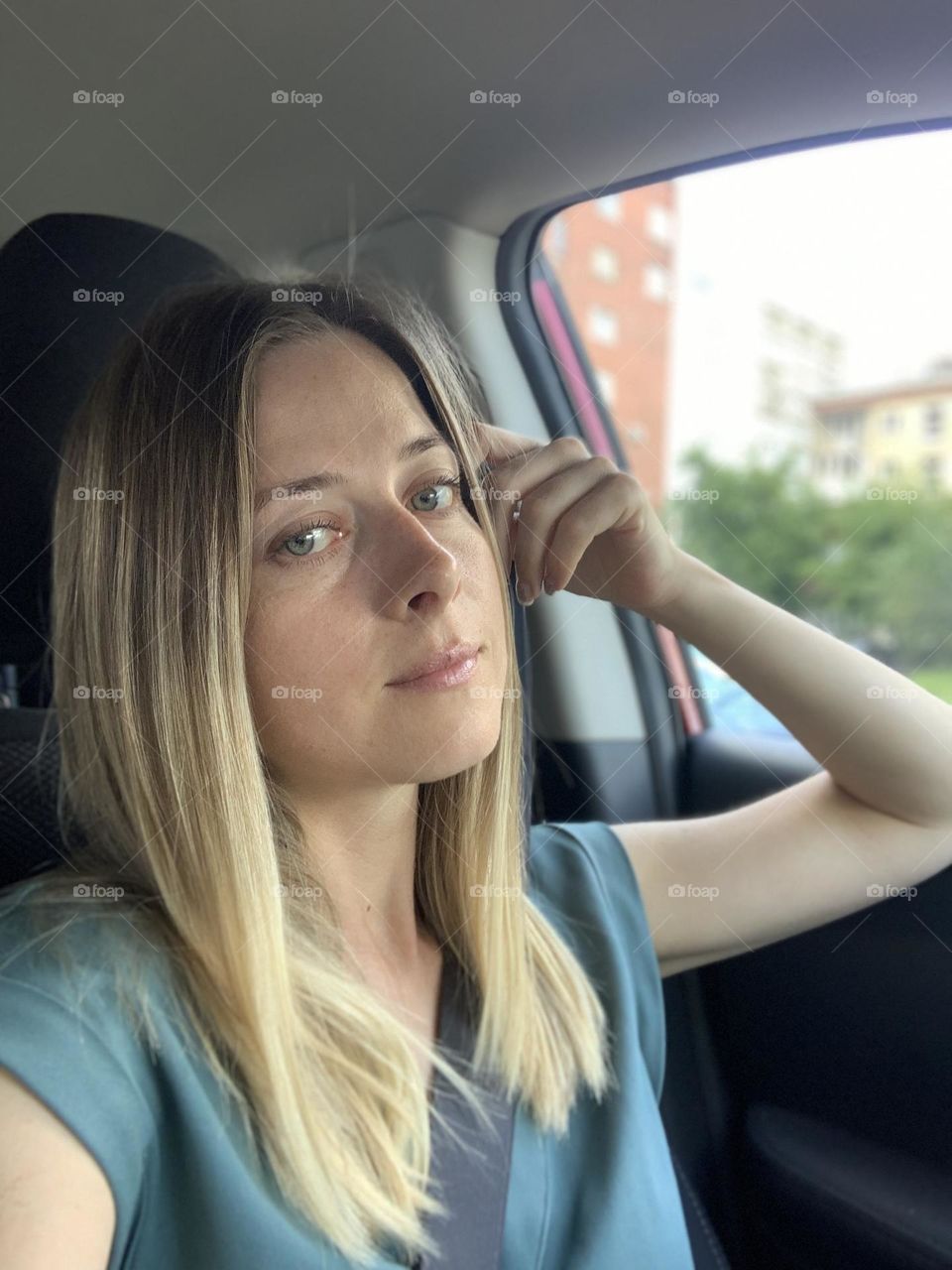 Woman sitting in the car near the window 