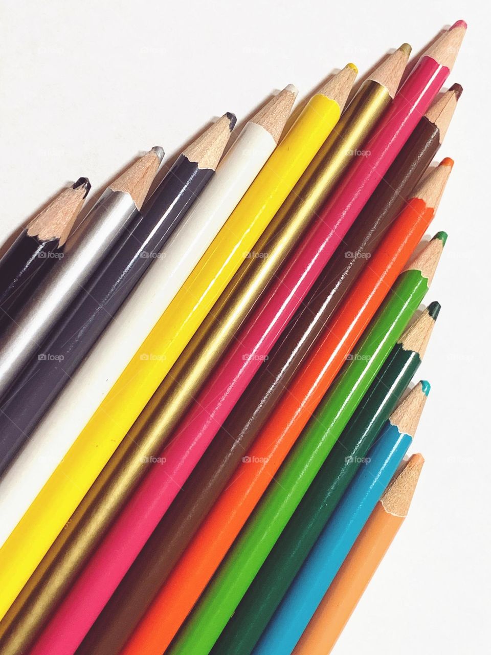 Colored pencils in white background.