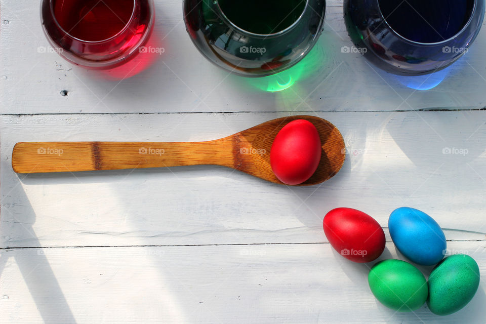 High angle view of easter eggs and colored bottles