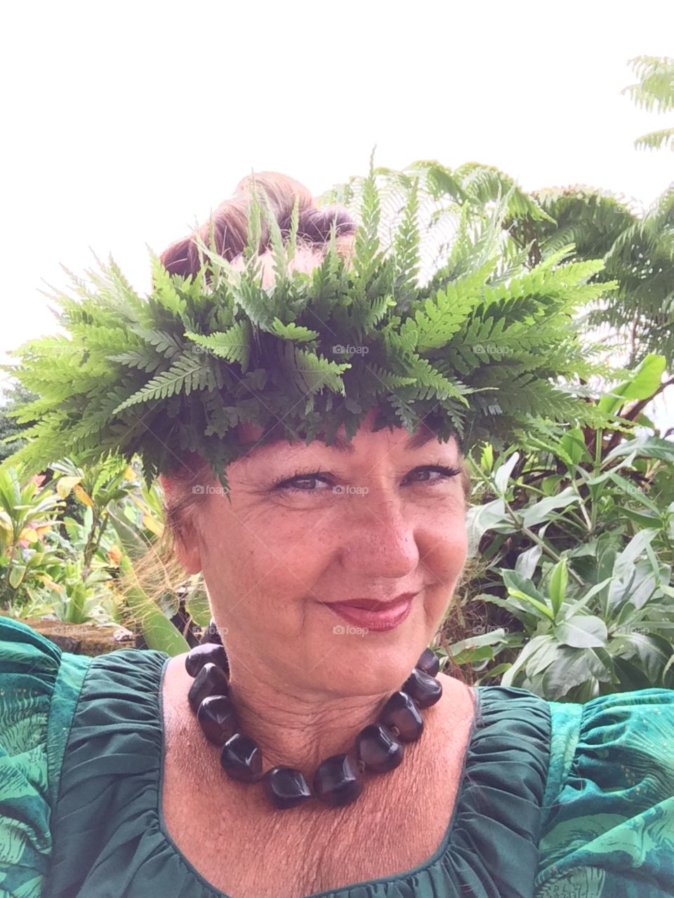 Woman wearing Hawaiian fern lei on head