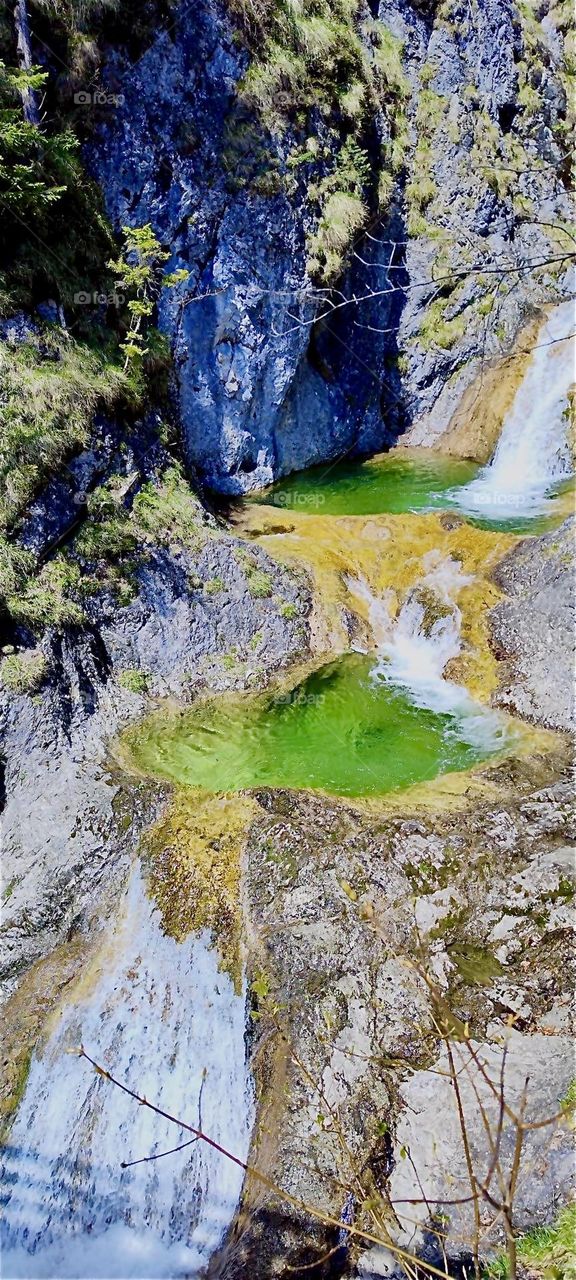 This is the local waterfall in the vicinity of „Bayerischzell“, a small town near the Alps in „Bavaria“, Germany called the „Grüne Gumpe“, the „Green Gum“ for the green color of the water in the basins on the bottom. 2024. Hypnotic Productions