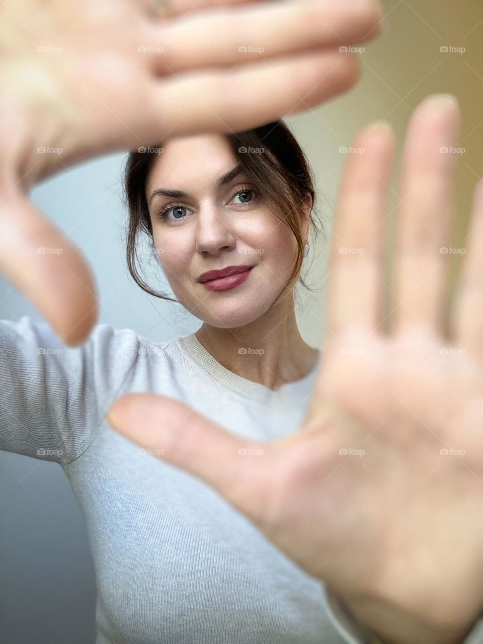 Portrait of a girl with hands in the foreground