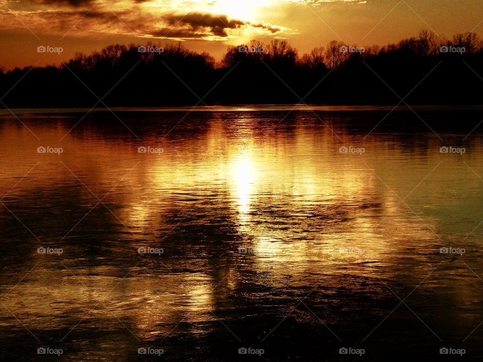 Frozen lake at sunset. 