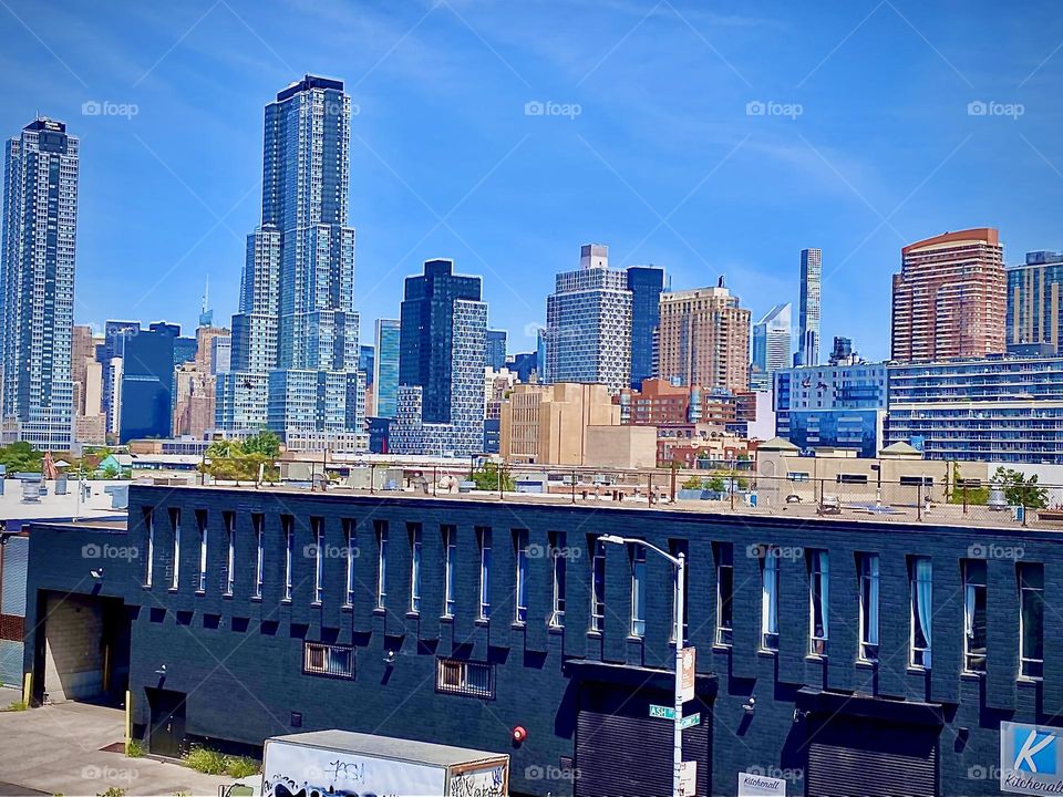 Views of LIC, Queens while ascending the staircase of the „Pulaski Bridge“ on the „Greenpoint“. Bklyn side on an early afternoon in July of 2022. Hypnotic Productions