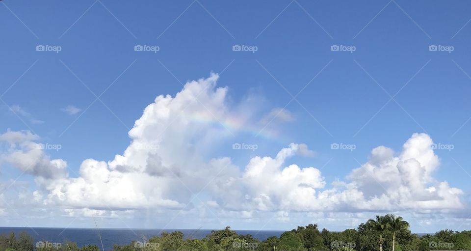 Scattered rainbow over the ocean. 🌈