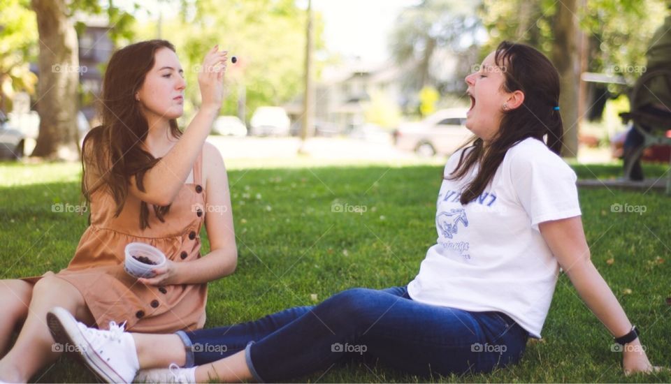 Sitting on the Church lawn on the last day of school playing catch with blueberries and teeth