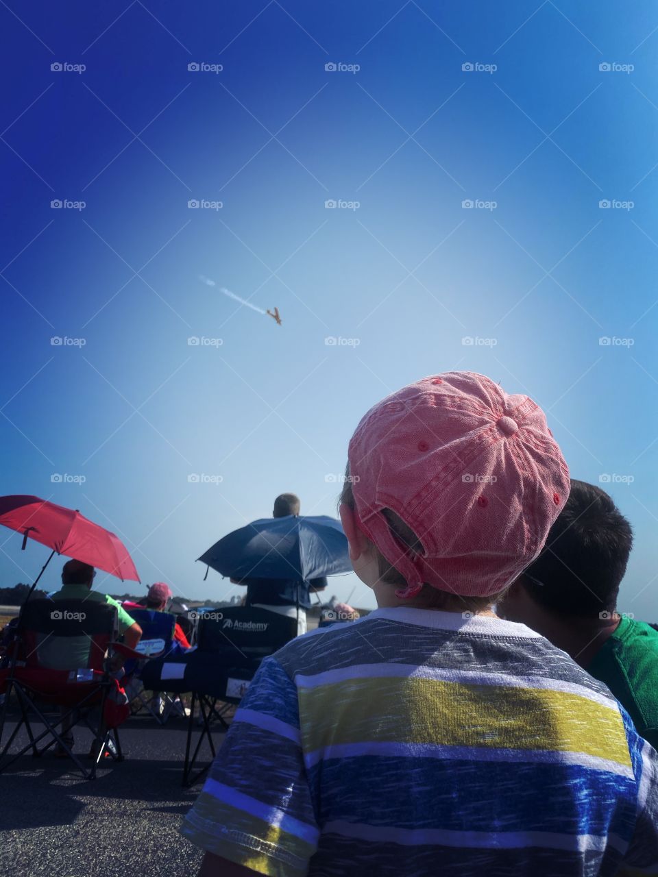 Little boy watching airplane fly