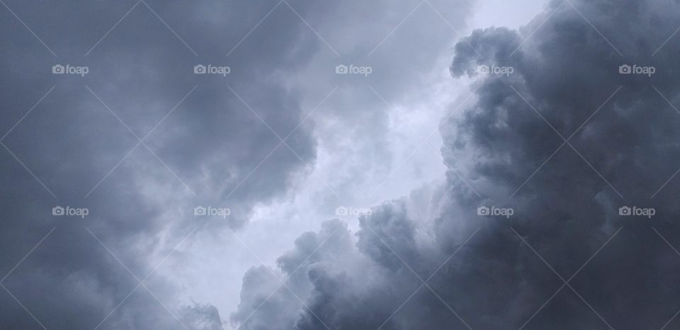 clouds background.Clouds become dark gray like a big smoke before rainfall.Thunderstorm is a storm with lightning and thunder.