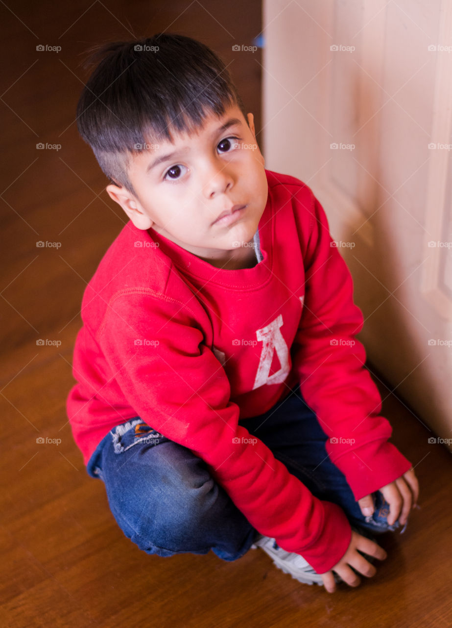 Cute boy sitting waiting for something 