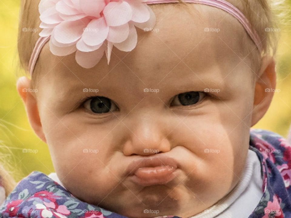 Young child pulling a rather funny disgusted facial expression 