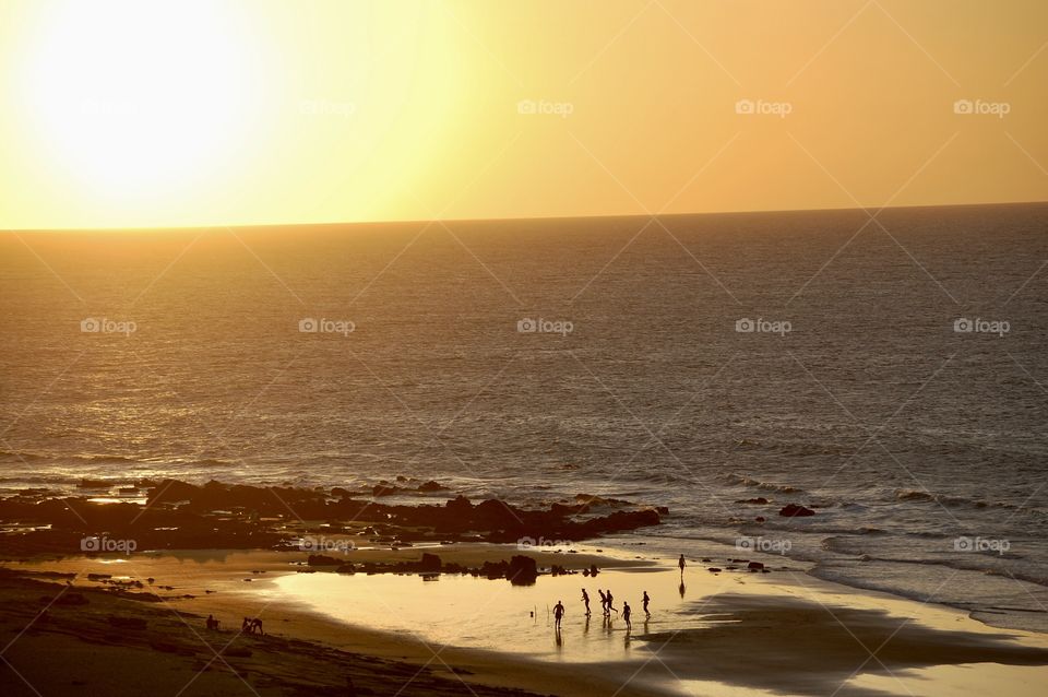 Boys playing football at sunset in the Jericoacoara beach. 