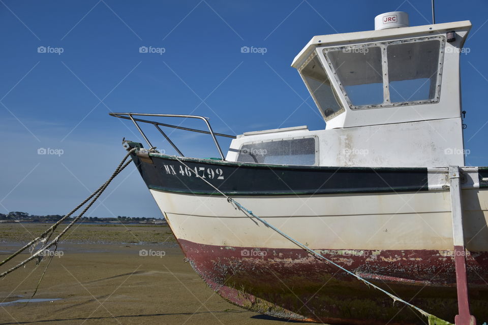 A ship on sand during low tide