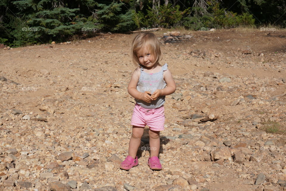 Toddler girl playing in the dirt