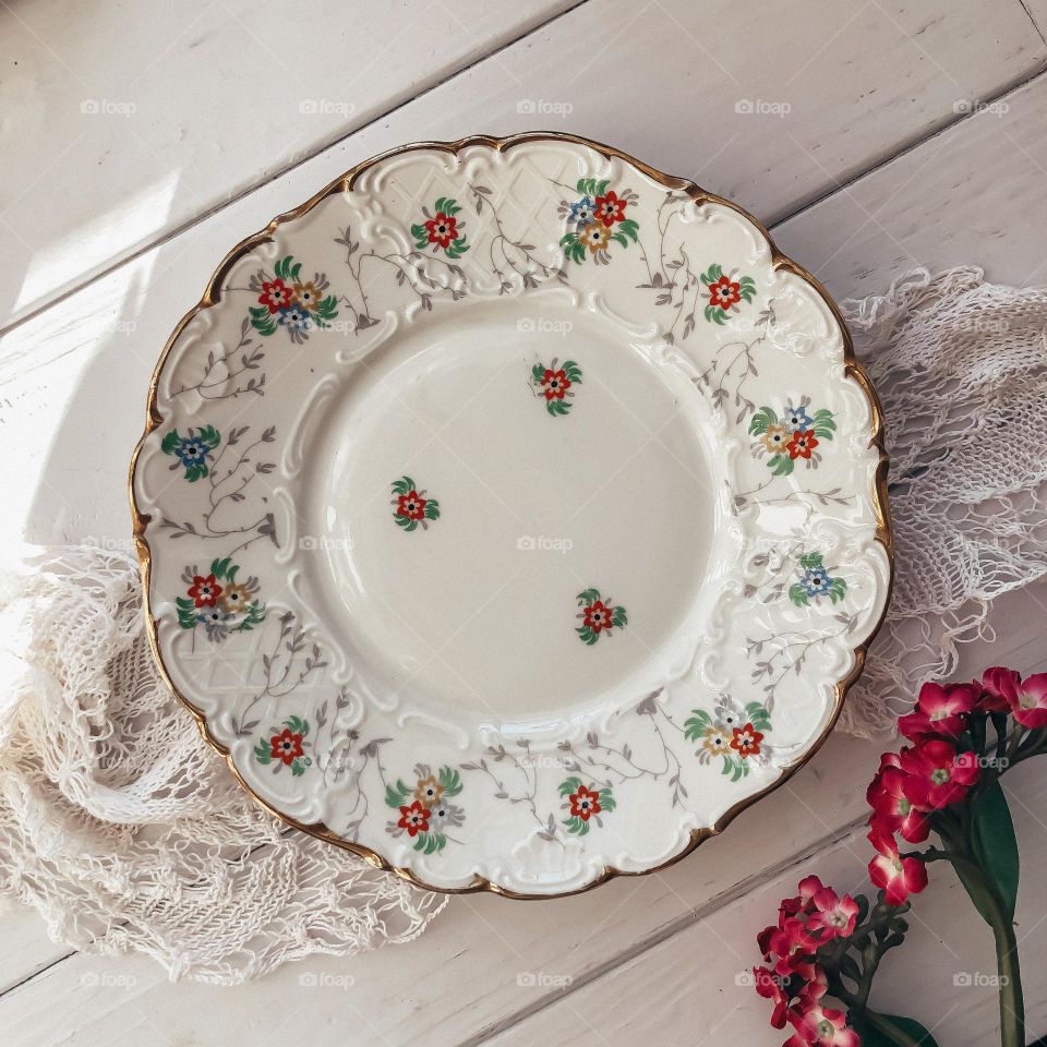 Antique porcelain dish with beautiful relief and small flowers