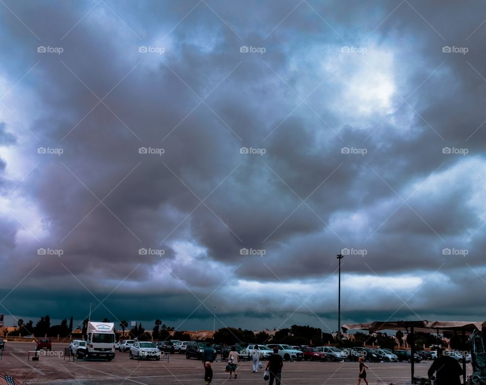 Reddish storm clouds over parking lot