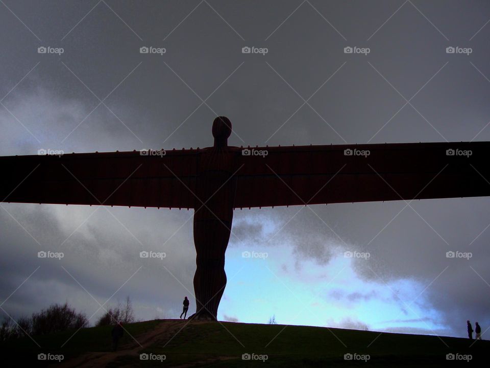 Dark storm clouds rolling over “The Angel of the North” with humans as a size comparison … taken with an older iPhone and very grainy…  pixels not the best but one of my favourite and memorable cloud photo’s 