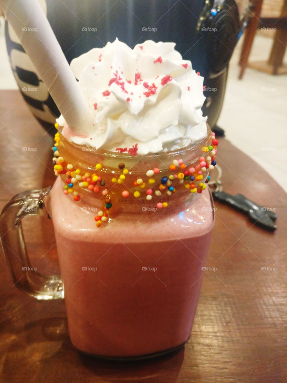 a jar full of smoothie topped with loads of vanilla ice cream