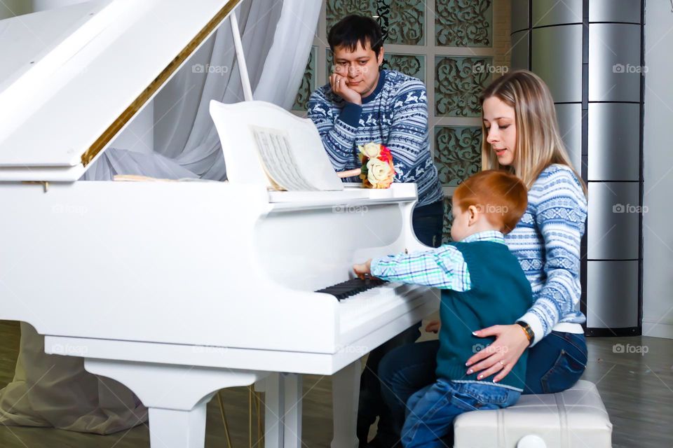 Family with a child playing the piano