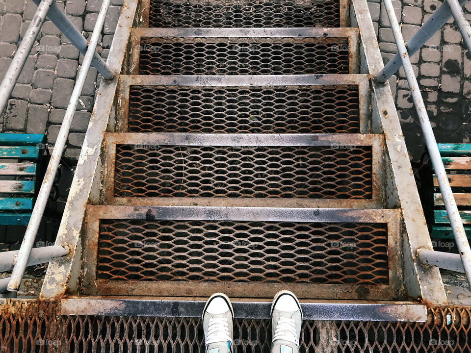 Symmetrical view of the iron steps before going downstairs 