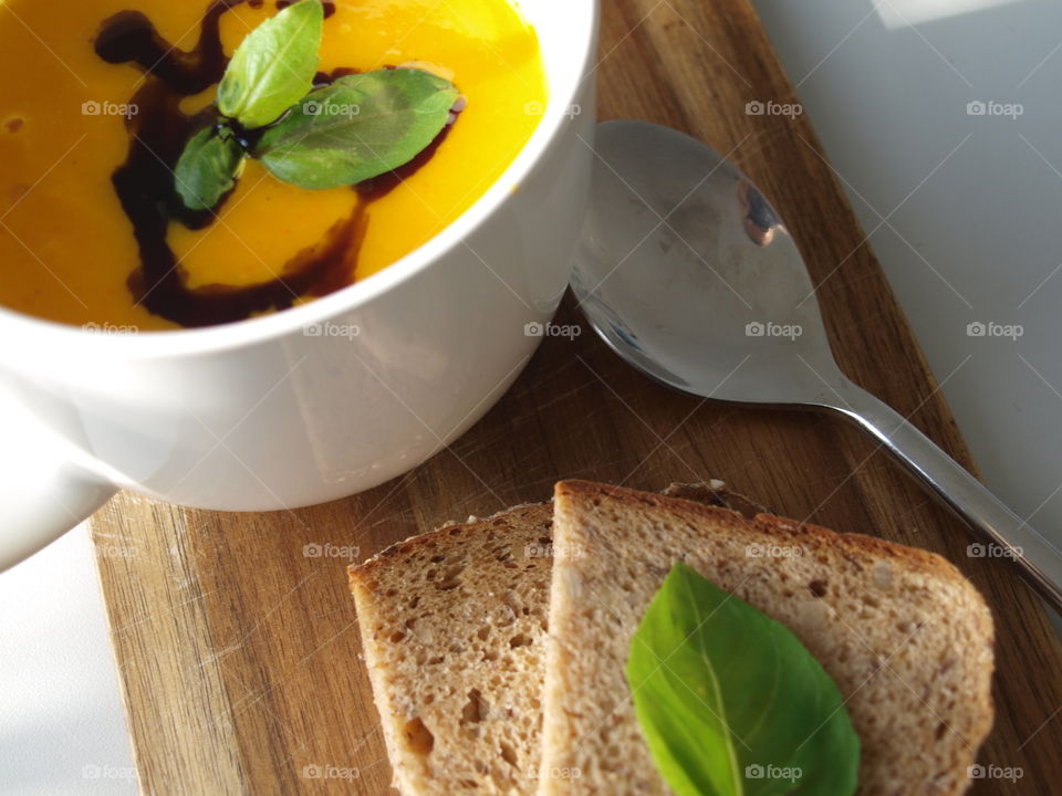 Delicious and pumpkin soup with bread