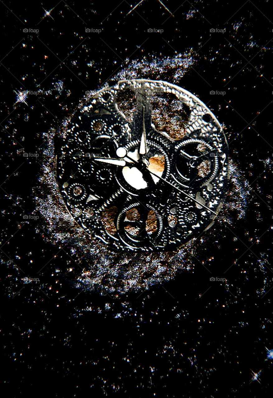 Time.  Clock mechanism on the background of the galaxy