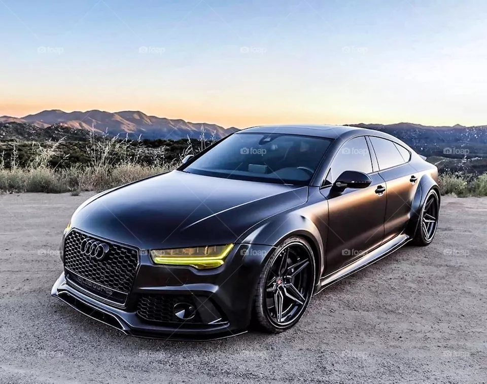 Black luxury car driving off-road on sunset sky mood.