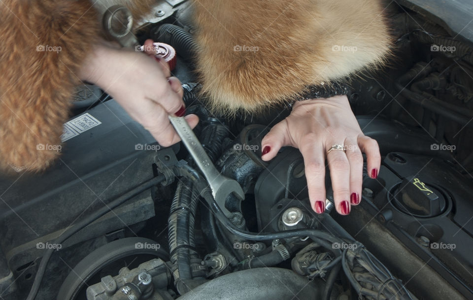 the girl is repairing the car