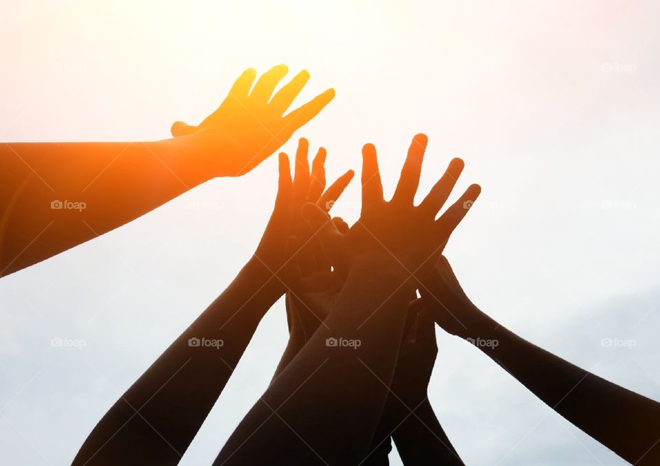 Silhouette hands up with sunlight .