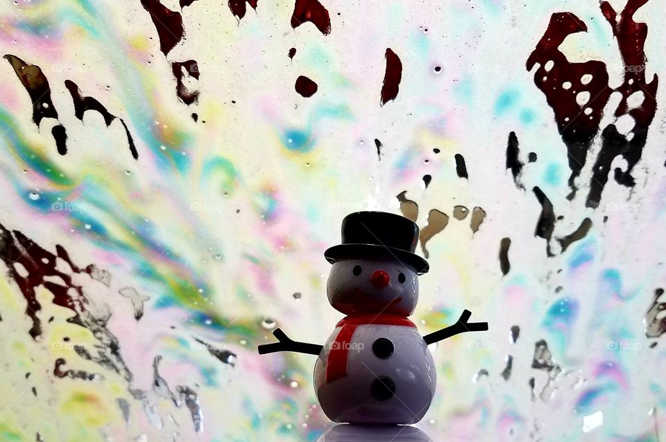 Frosty going through the car wash.  We have a snow man on our dash of our car.  i love taking pictures with  different backgrounds. This picture reminded me is Christmas lights.