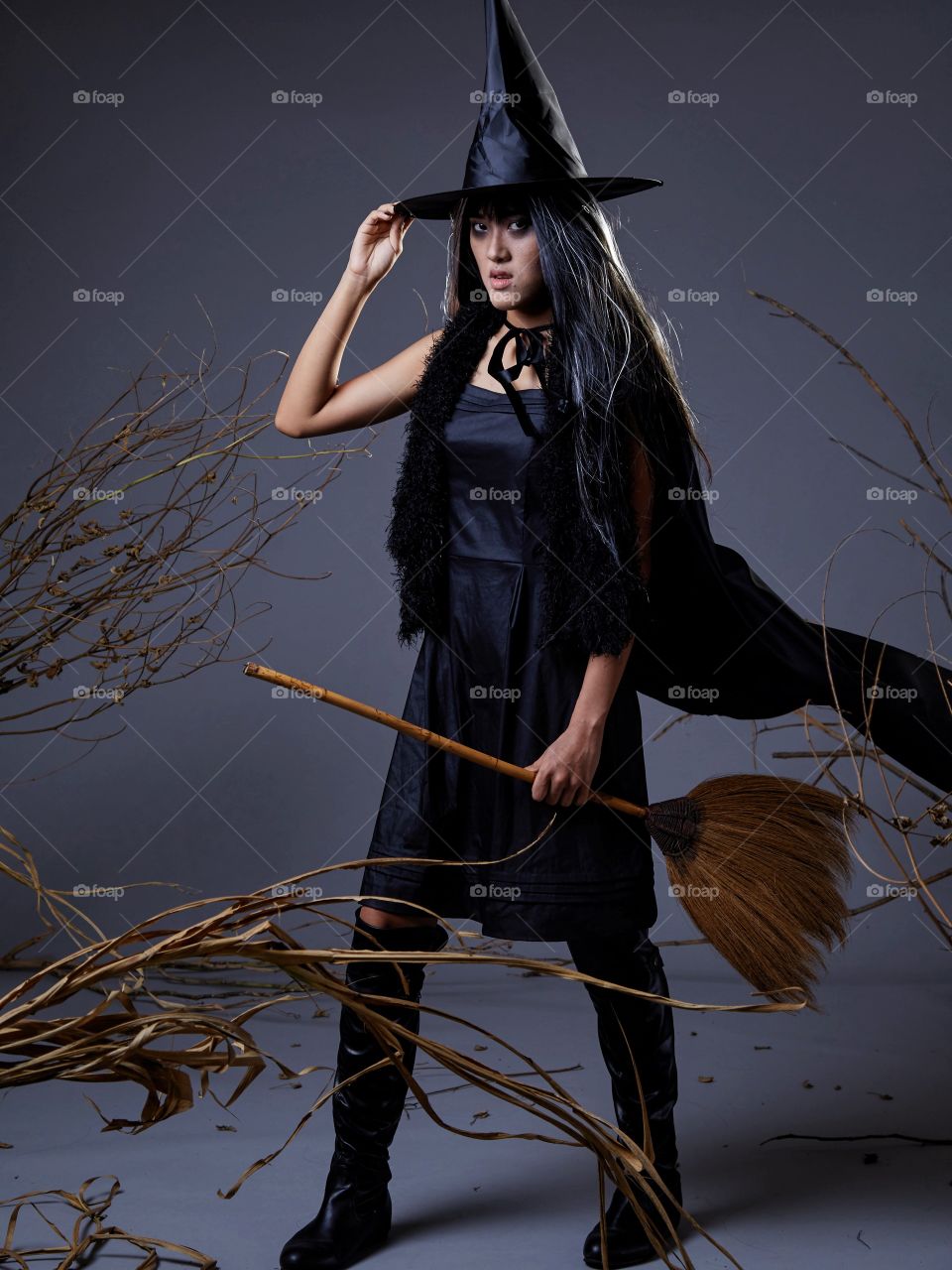 Woman in witch costume and pointy hat 