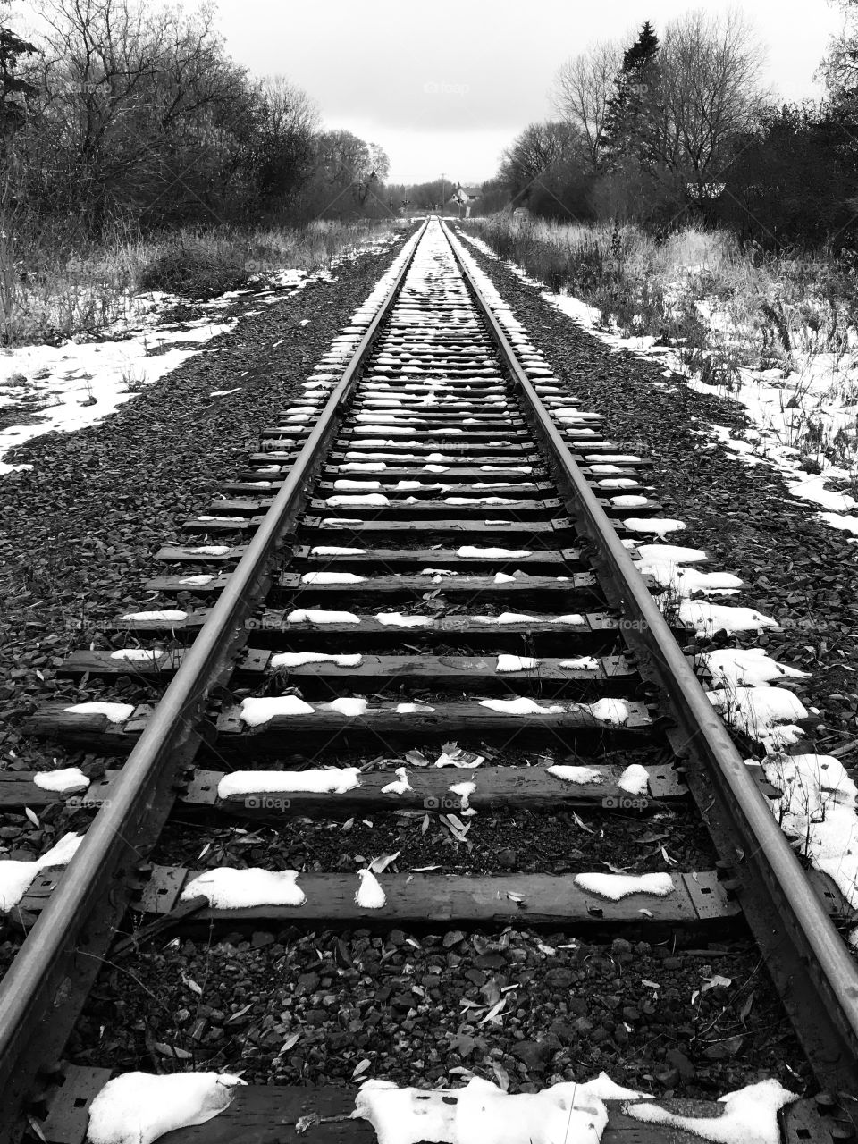 Snowy railroad track in black and white