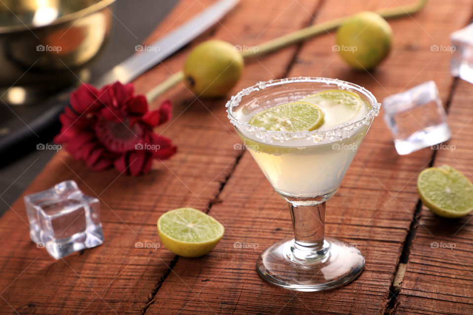 Fresh lemonade in a glass on wooden background