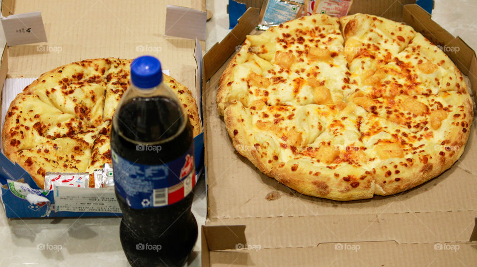 Enjoying a pizza on hot summer days with chilled coldrink and coldy floor is my best flatlay