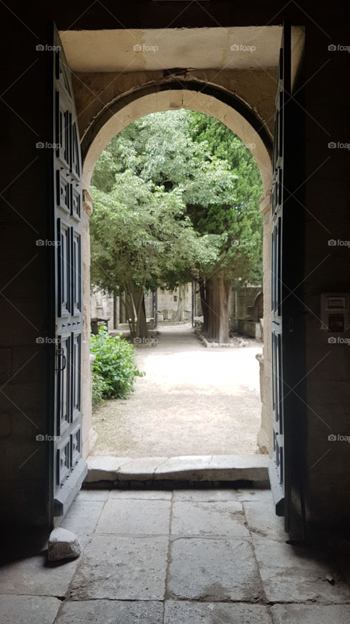 Through the opened doors of the Saint-Honorat church, Alyscamps, Arles, France.