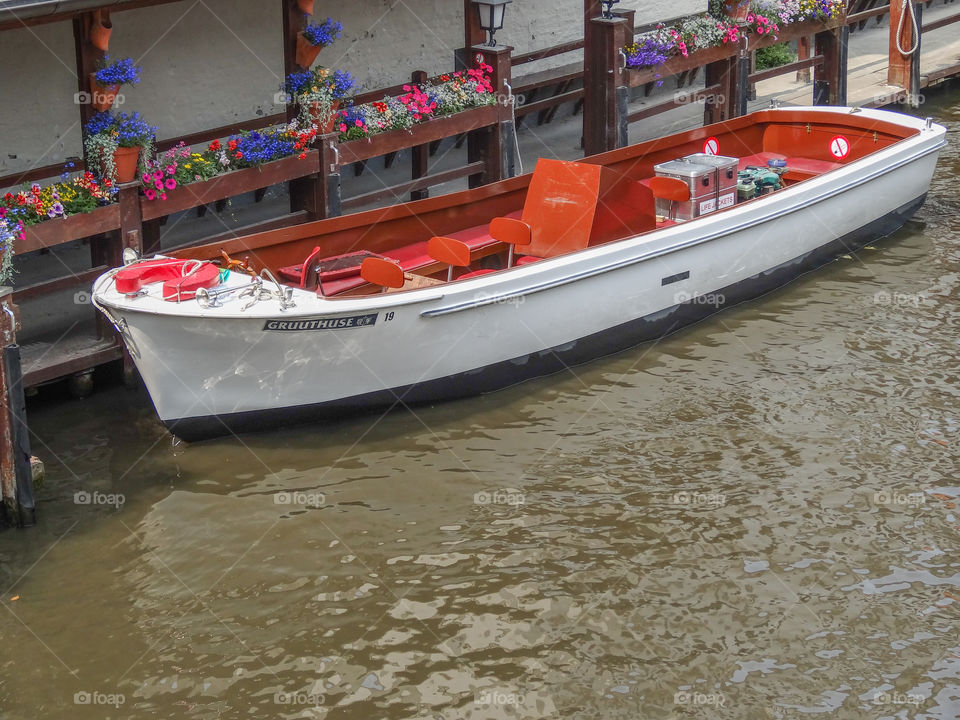 Bright red and white boat on a canal in Europe. 