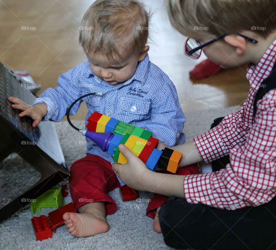 Little brothers playing with Lego blocks