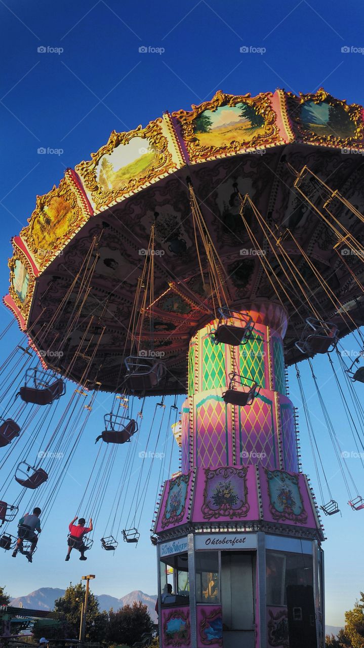 Some kids enjoying the Giant swing ride at  the carnival