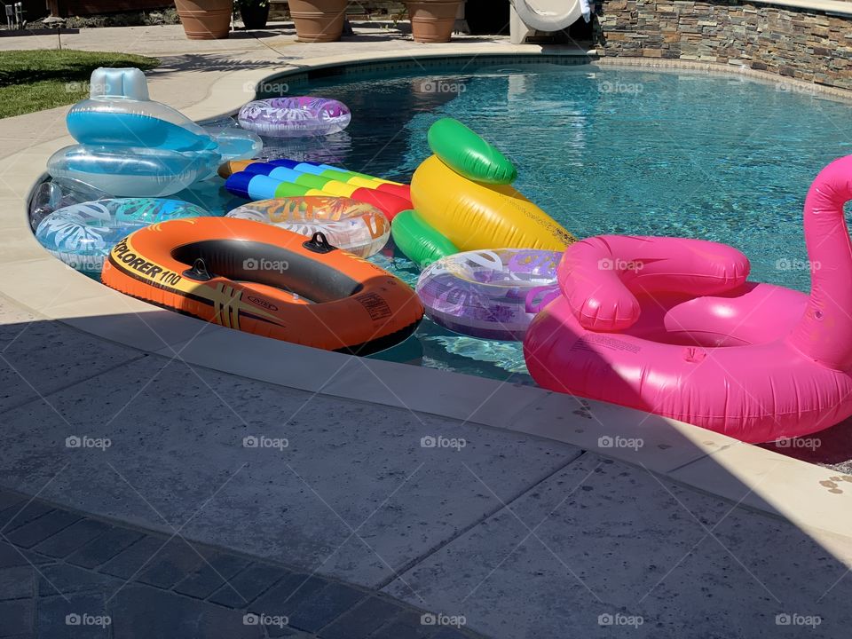 Our pool with a bunch of floaties, waiting for guests to arrive for a promotion/graduation party.