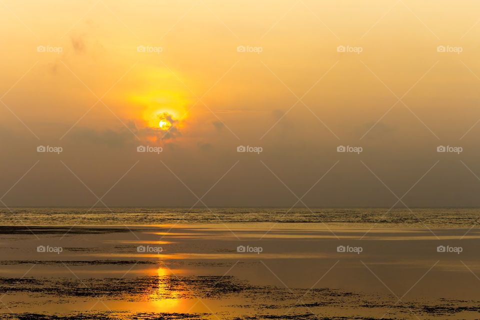 Beginning sunrise over seashore