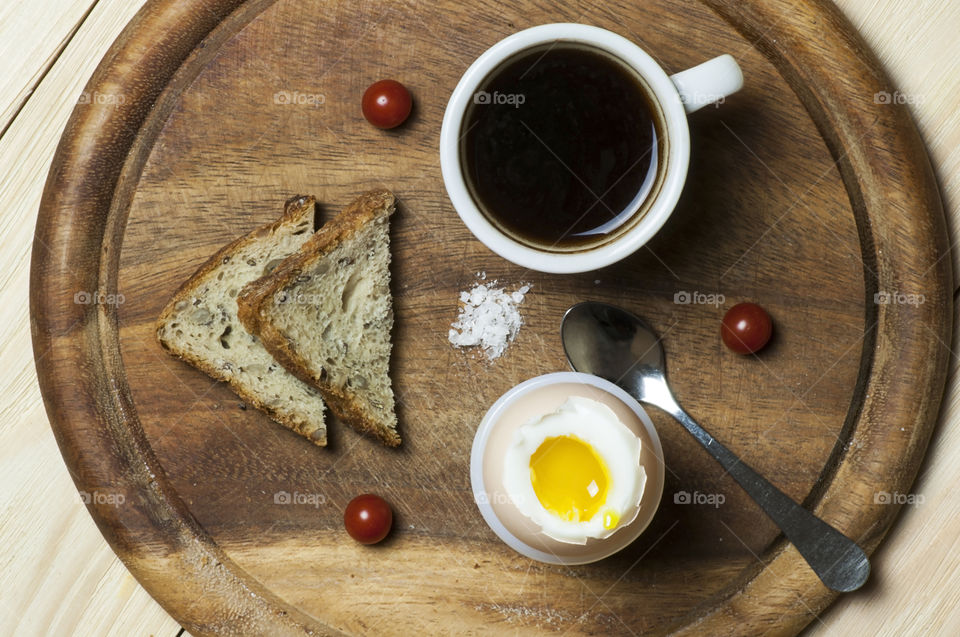 Light breakfast with boiled egg and cup of coffee