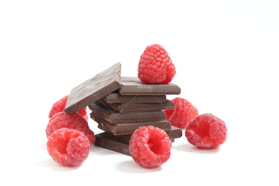 Pieces of chocolate and raspberries.