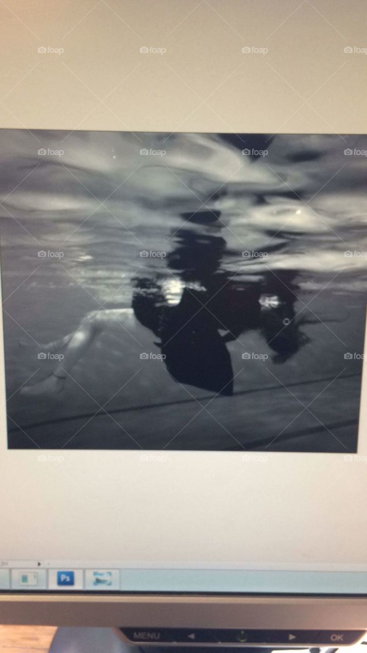Editing a black and white photo of a drowned girl in water.