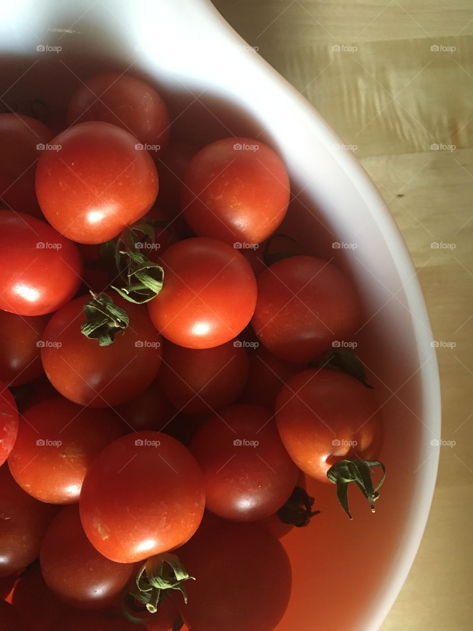 Bowl of tasty plump red cherry tomatoes