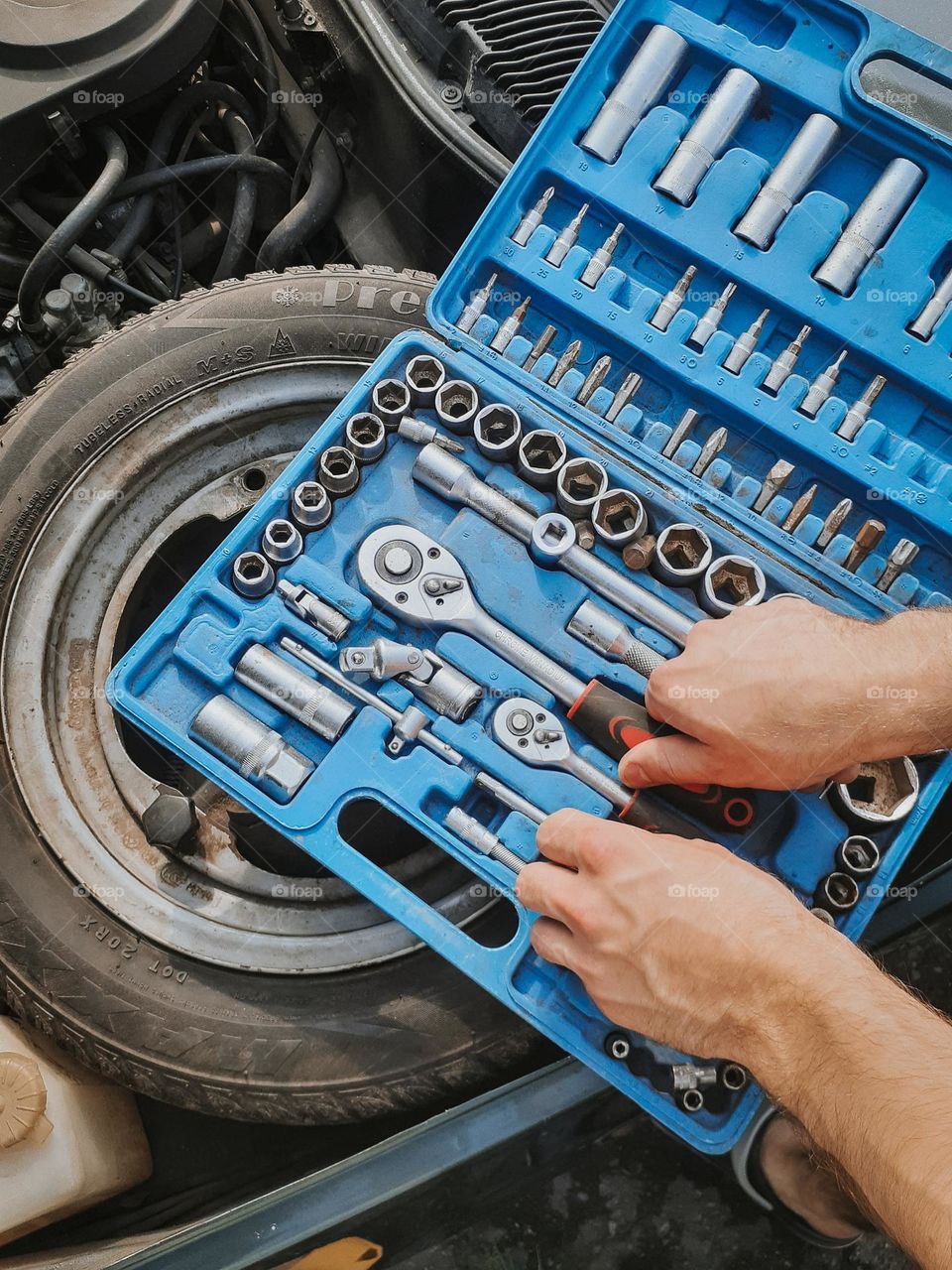 A mechanic cleans up his toolbox