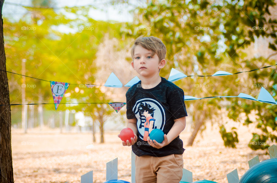 beautiful child playing with ball on the farm
