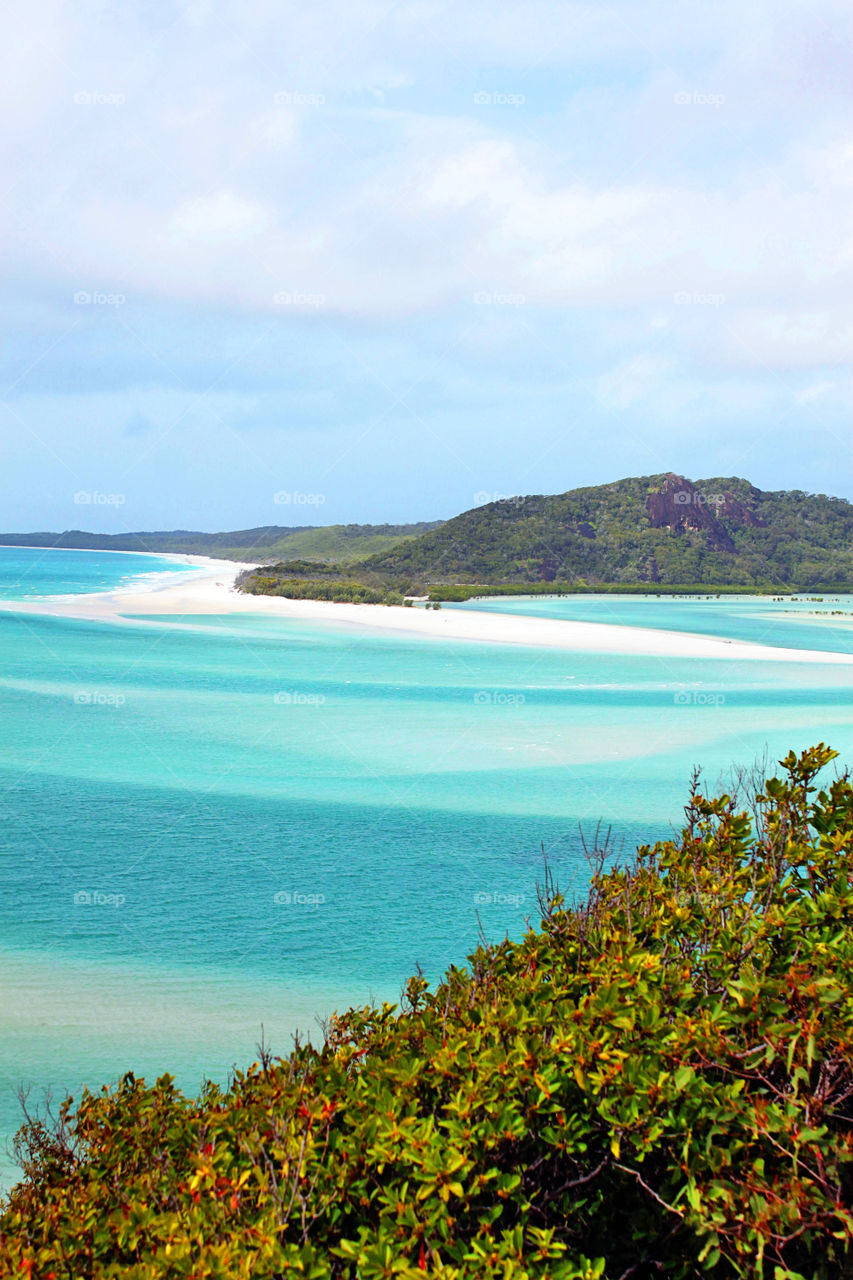 Scenic view of a island against cloudy sky