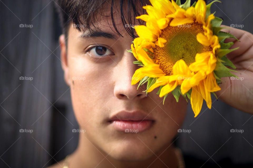 Teen boy with a sunflower